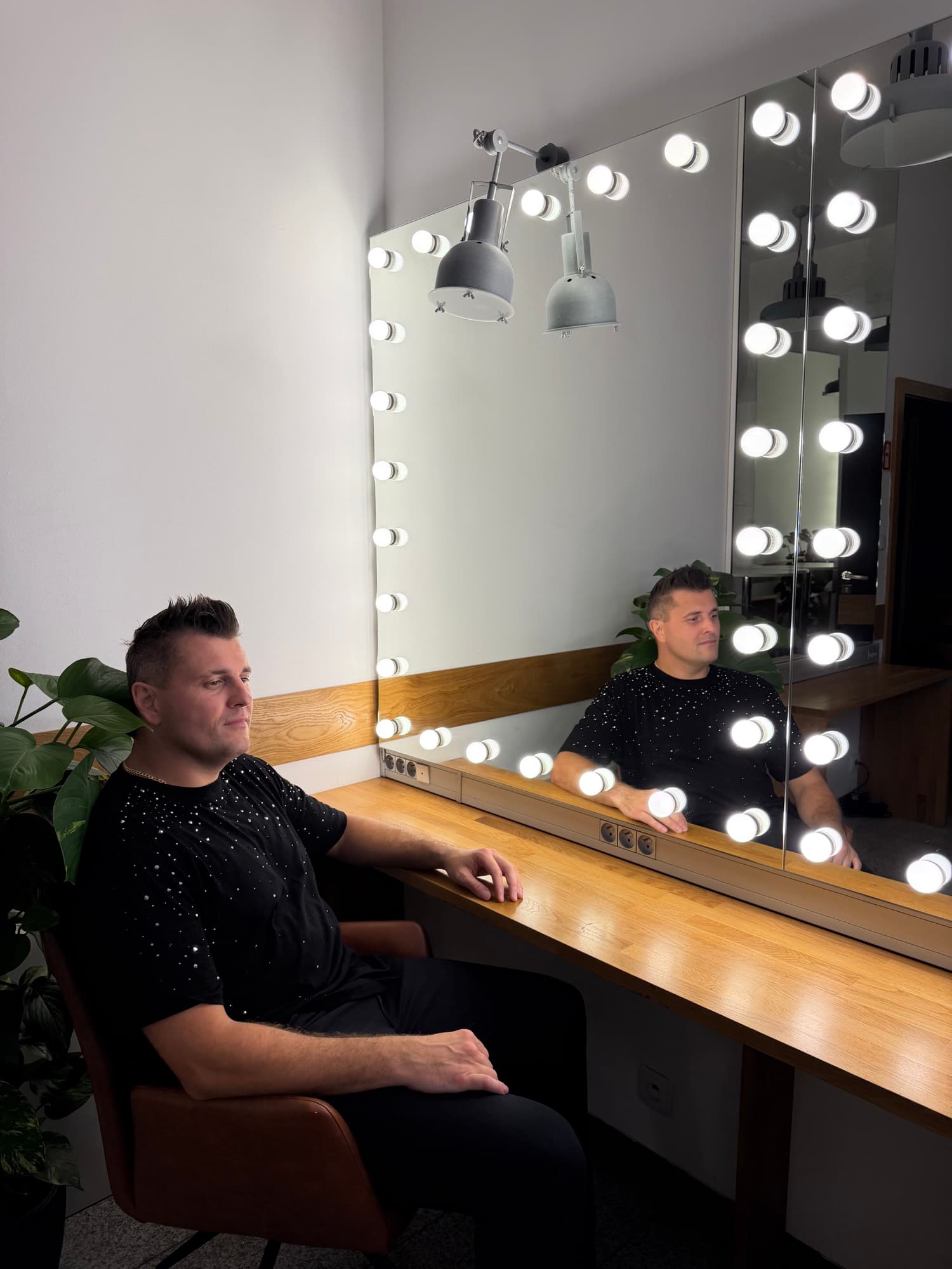 Rafciu w garderobie przed lustrem z żarówkami